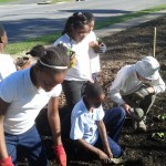 Students in the Good HELP program prepare and plant a vegetable garden in East Lake.